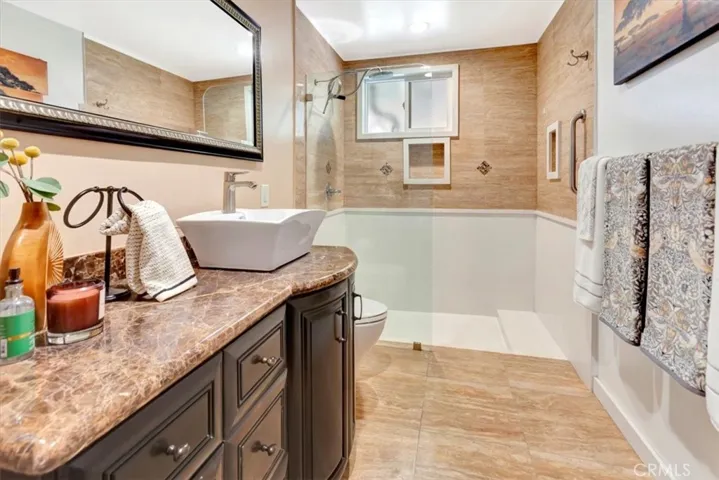 Downstairs three-quarter bath with walk-in shower and (unseen) tall cabinet for linens and storage.