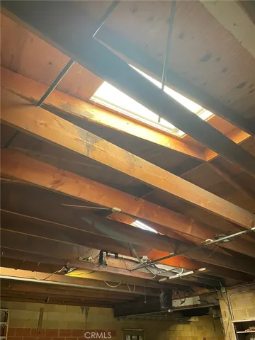 Ceiling open rafters, two sky lights.