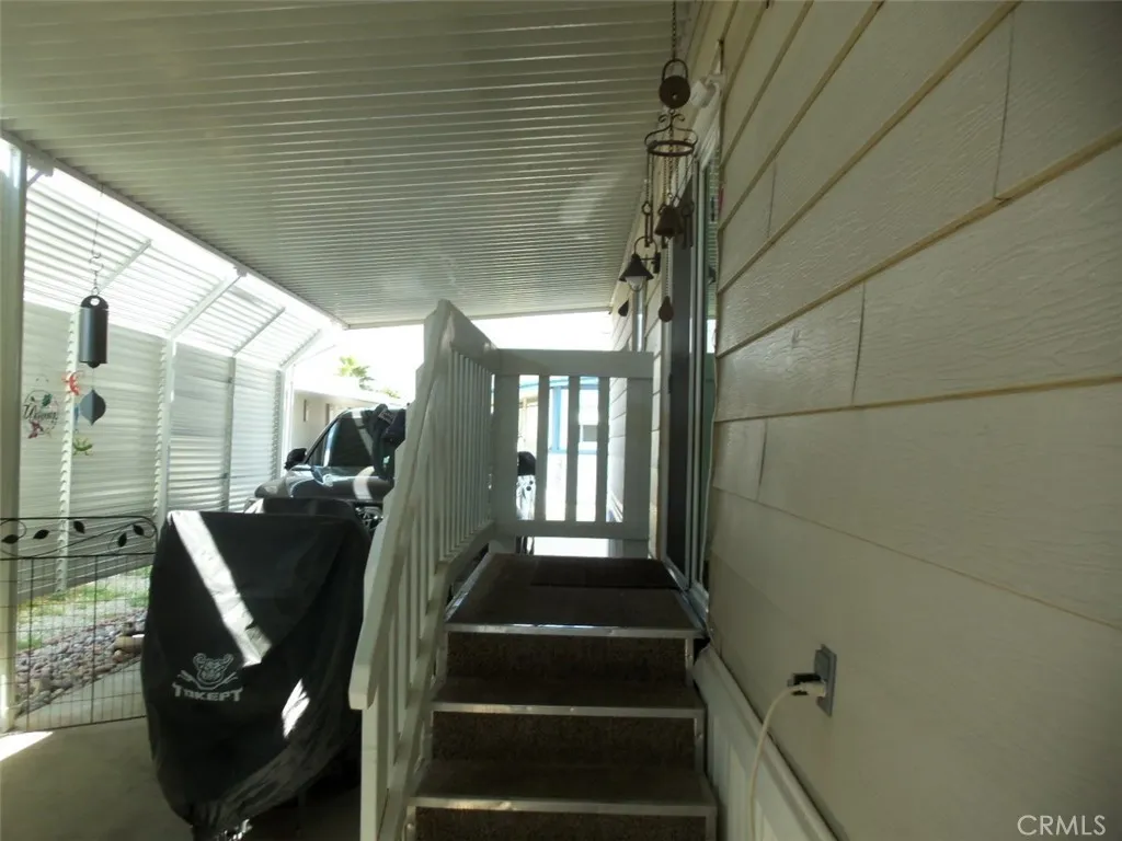 Carport entrance through dual glazed sliding glass door