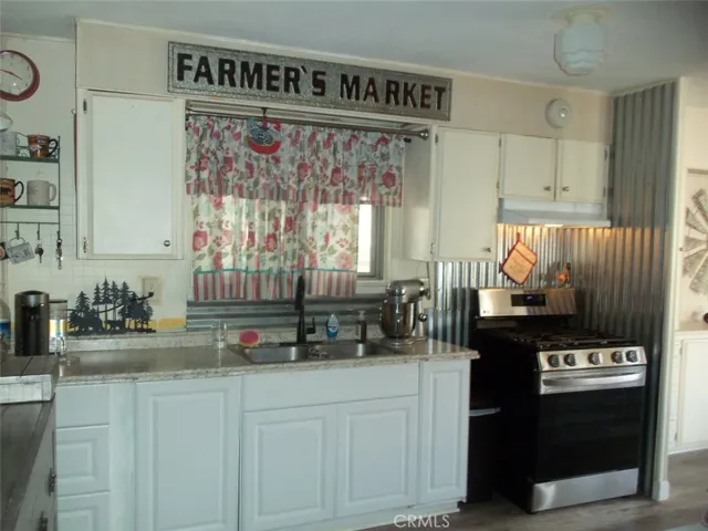 Kitchen w/stainless steel sink window and dlx Gas stove.