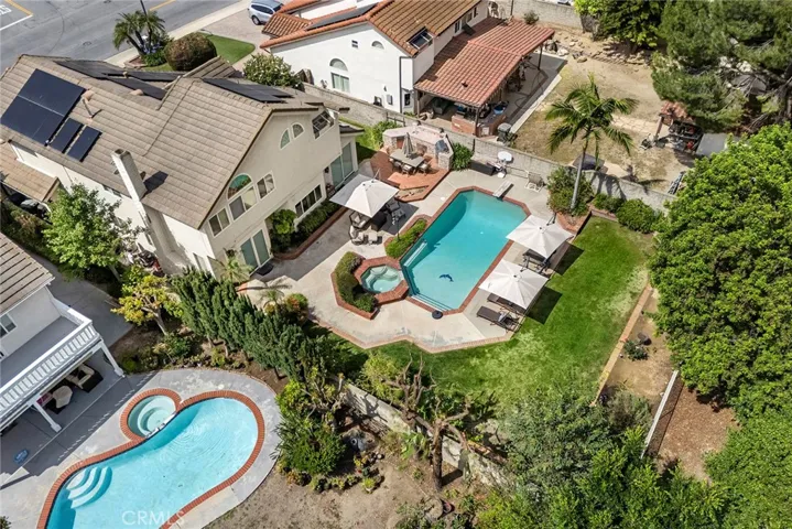 Bird's eye view allows you to appreciate this beautiful executive level home. It boasts 2788 sq ft of living space plus additional space of 3 car garage. Gracious lot of 13,273 sq ft means your home will be the "gathering place." There are grassy spaces as well as pool, spa, and outdoor kitchen. New solar panels are paid off in full.