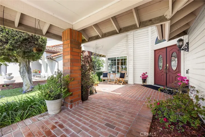 Welcoming brick path leads to grand dual door entry. Covered porch area allows you to greet visitors or Halloween goblins looking for trick-or-treats. This space is conducive to friendly interactions with neighbors.