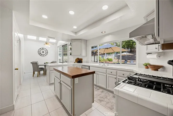 Note the gas range on the right side of picture. Gas ranges are ideal for cooking because of their instantaneous temperature control. The breakfast nook is at the far end of the kitchen.