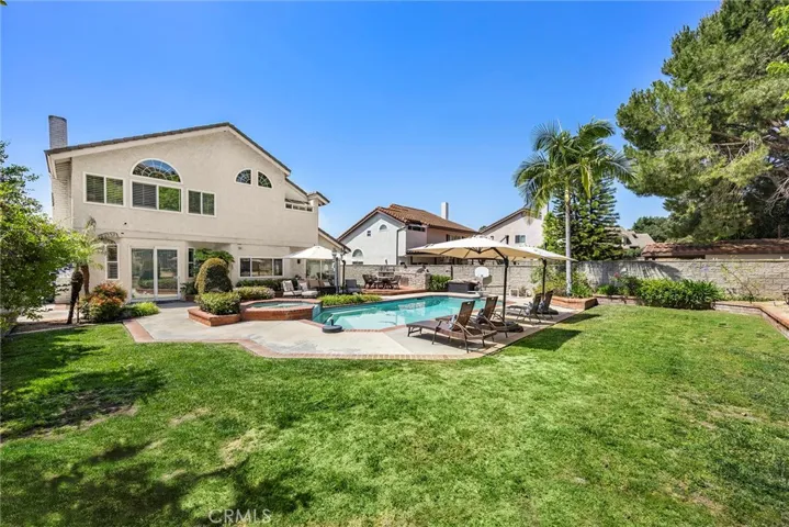 Expansive lot over 13,000 square feet offers premium outdoor entertaining. Pool parties, barbeques, and al fresco dining come easily. Grassy spaces provide room for play and gardening.
