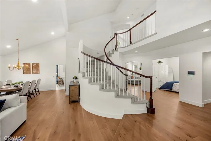 Sweeping staircase leads to private bedrooms upstairs. Downstairs landing leads to a ground level room, currently used as a guest room.