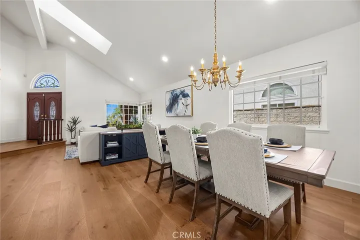 Vaulted ceilings provide a spacious feeling. Note the new canned ceiling lights.  Also, this view shows off the  beautiful and warm plank flooring.