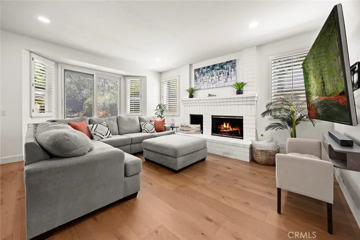 The fireplace makes this family room conducive to lingering and lounging. Raised hearth allows for extra seating and is a great place for presents during celebrations. Can't you imagine a Christmas tree in the corner?