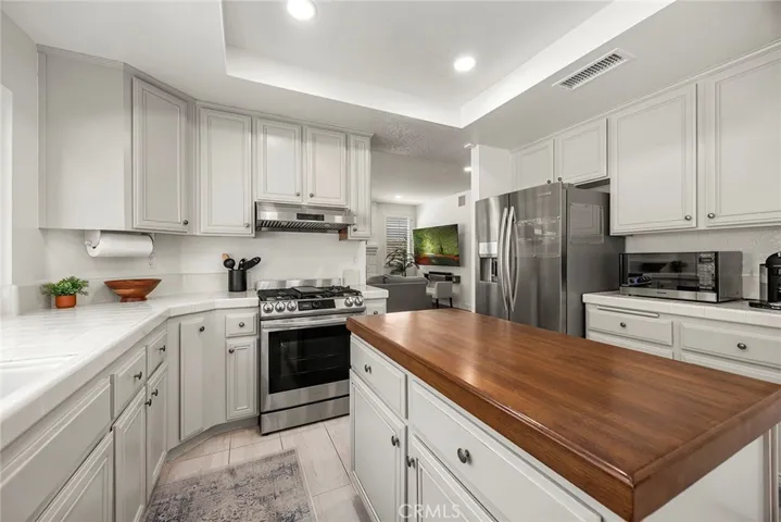 Fresh and functional describes this kitchen. Stainless steel appliances, lots of counter space and a wood block kitchen island provides all the ingredients for a great kitchen.