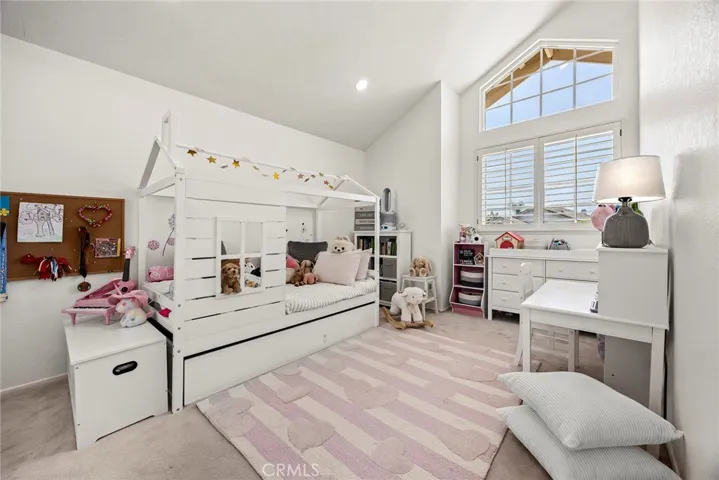 Bedroom #4  is light and bright with vaulted ceiling and windows looking out to the front of the home.