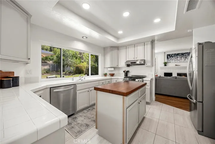 This gourmet kitchen opens to the family room. A wall of windows over the sink allows views of the backyard while in the kitchen.