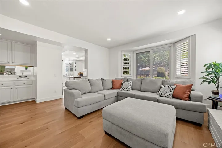 This home was made for entertaining. Note the wet bar in the corner and the direct access to the kitchen beyond. Sliding glass doors beckon to the backyard.