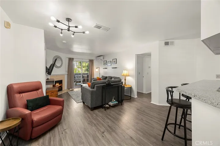 View from the entry showcasing the inviting living area and open interior flow. Fireplace has been digitally enhanced.