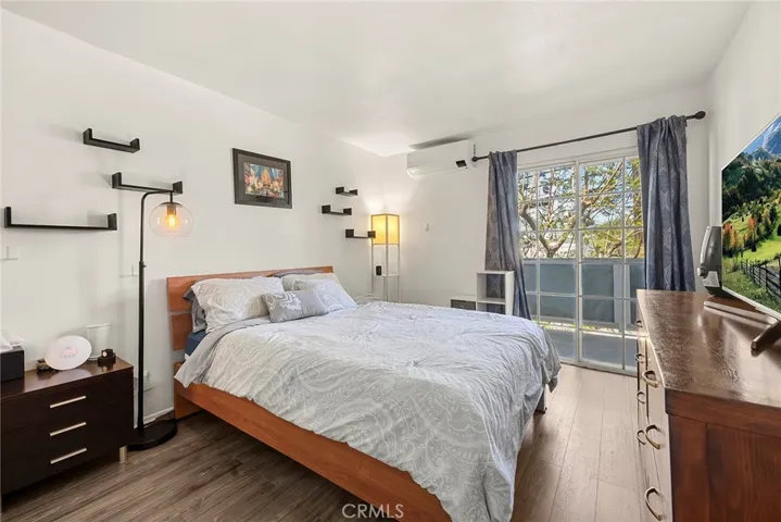 Spacious primary bedroom featuring a private balcony, walk-in closet, and en-suite bath with dual sinks.