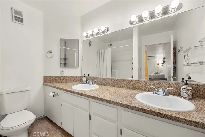 Primary en-suite bath featuring dual sinks, generous counter space, and ample storage for everyday convenience.