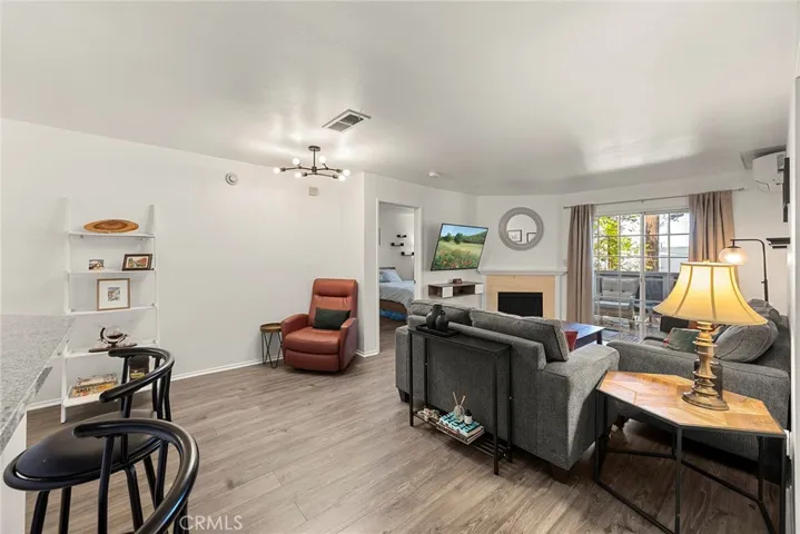 View from the kitchen entry showcasing the living area and sliding glass door leading to the private patio.