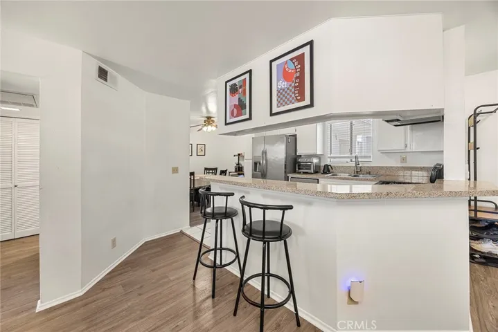 Open kitchen with breakfast bar seating, overlooking the dining area for easy everyday living and entertaining.