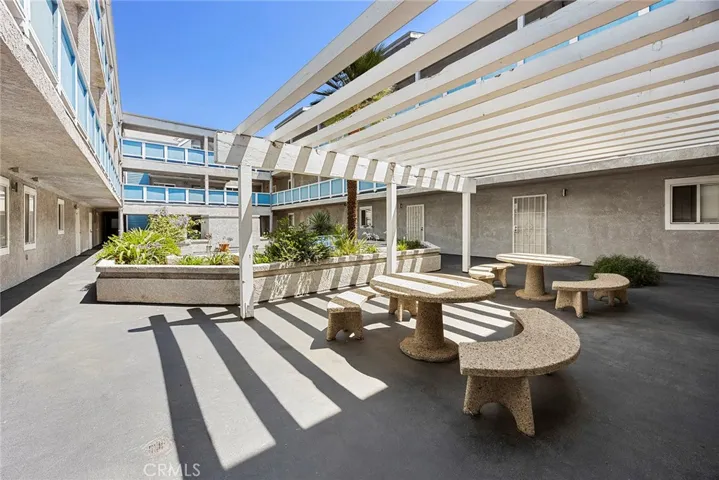 Inviting community courtyard with shaded seating areas perfect for relaxing or gathering with guests.