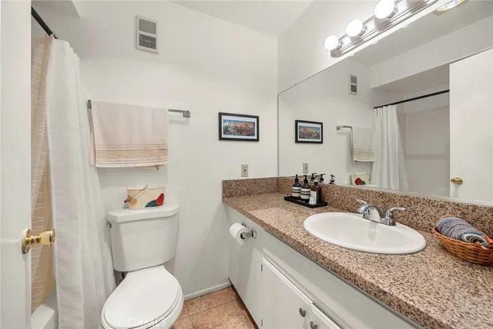 Hallway full bath features a shower/tub combo, generous counter space, and a heated lamp for added comfort after your shower or bath.