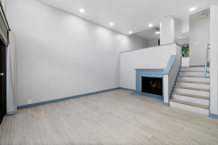 Living Room with High Ceilings and Wood Burning FP