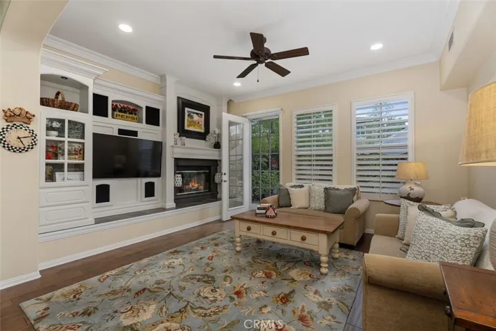 Spacious Family Room with Custom Media Niche and Inviting Fireplace.