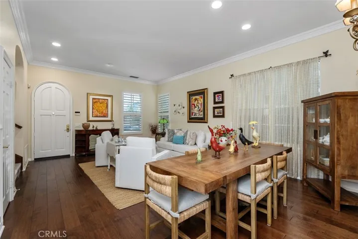 Living Room/Dining Room Combination with Rich Wood Floors, Wainscoting and Crown Molding.