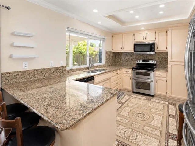 Spacious kitchen with large counter space and bright backyard-facing window.