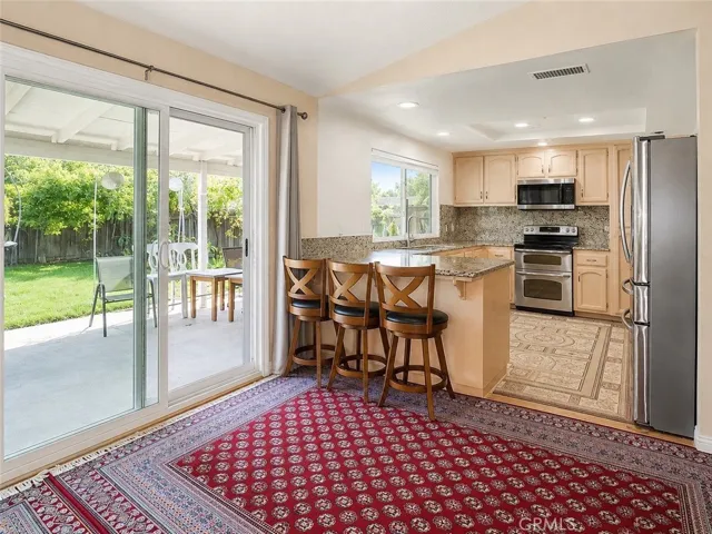 Open dining and kitchen area with easy access to the covered patio.