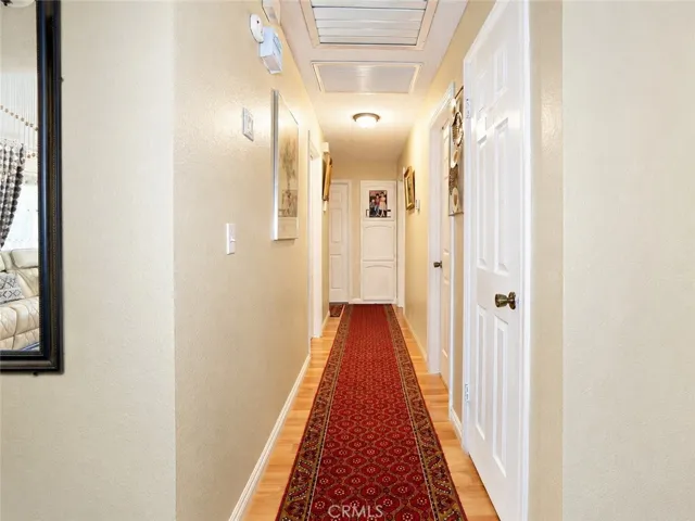 Bright hallway connecting the home’s bedrooms and living spaces.