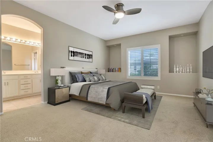 Primary suite virtually staged with view to bath