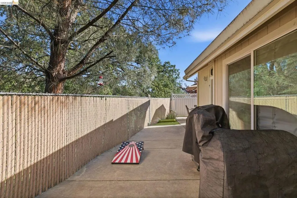 Fenced backyard with a patio