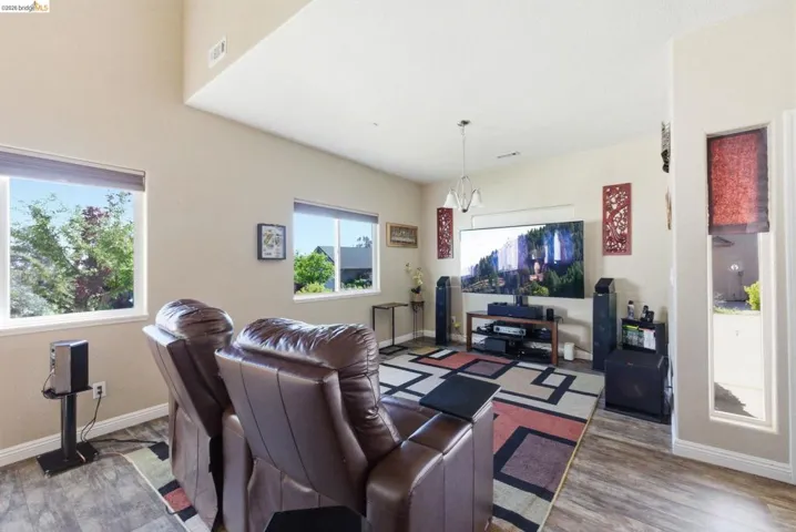 Living area featuring wood finished floors and suspended lighting