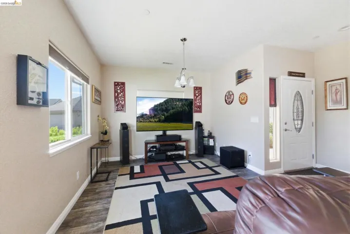 Living room featuring baseboards and dark wood-style floors