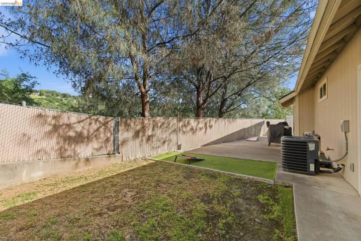 Fenced backyard with a patio