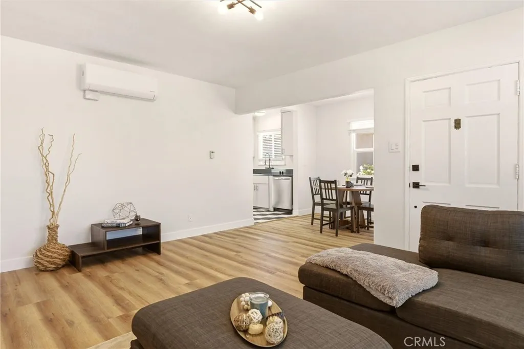Another angle of the living space in the single family home, looking toward dining and kitchen areas.