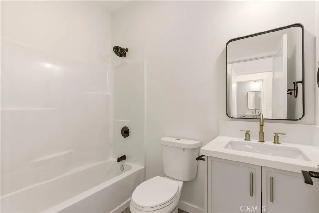 Unit B - Designed with a modern aesthetic, the primary en-suite bathroom features brand new finishes and a clean contemporary feel.