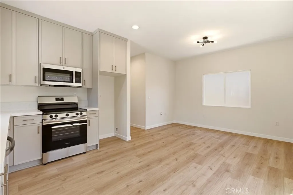 Unit B- Step into a bright open-concept living space with 9ft ceilings, filled with natural light and designed for comfortable everyday living.