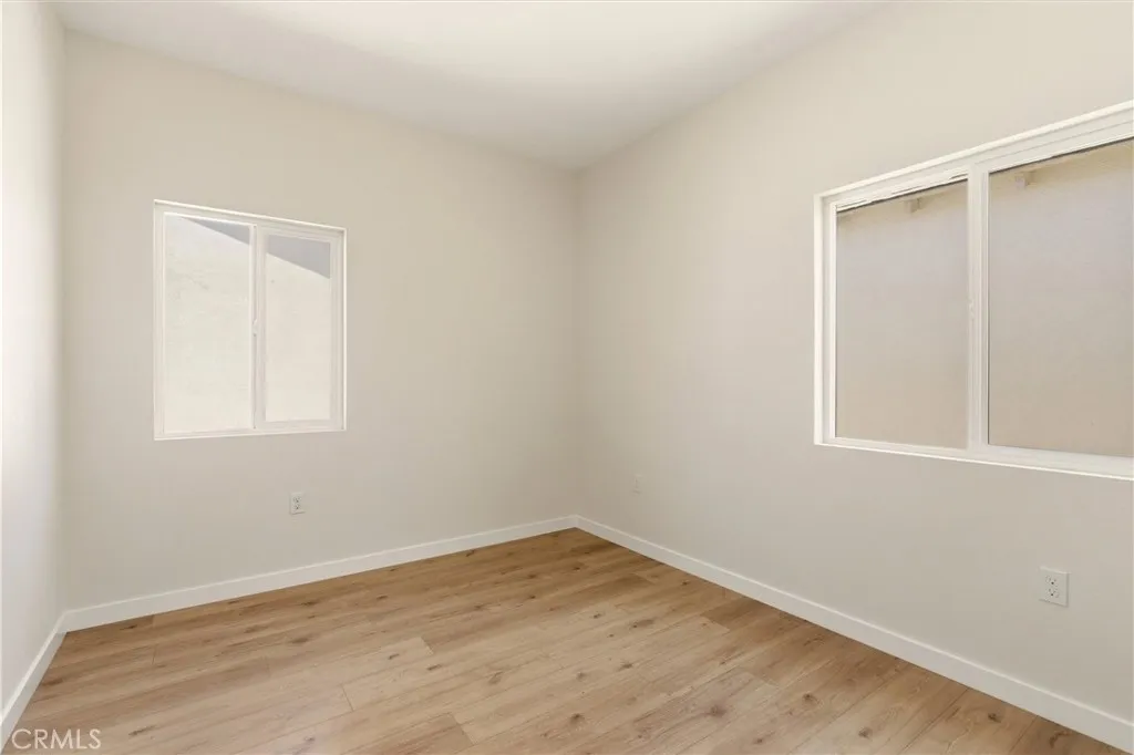 Unit B - This secondary bedroom offers flexibility for guests, family, or a home office.