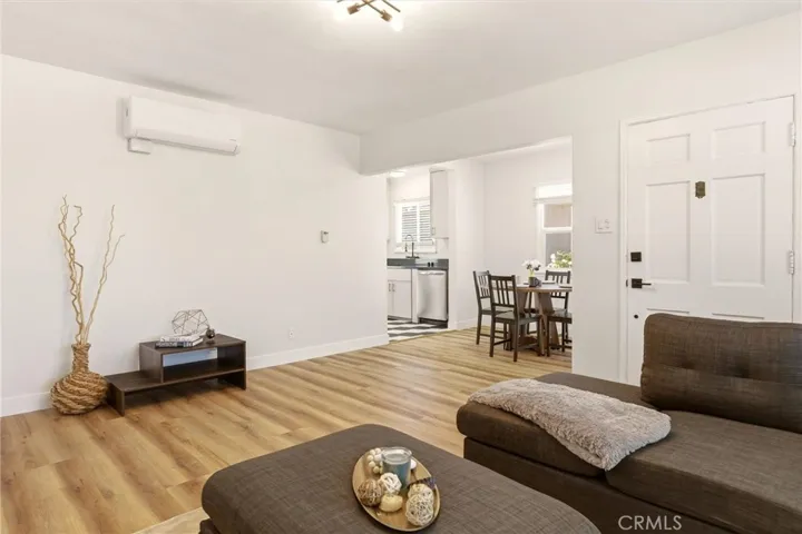 Another angle of the living space in the single family home, looking toward dining and kitchen areas.