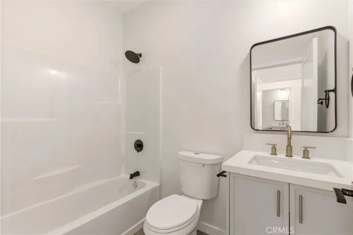 Unit B - Designed with a modern aesthetic, the primary en-suite bathroom features brand new finishes and a clean contemporary feel.