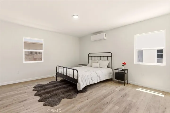 The spacious primary suite offers a peaceful retreat with abundant natural light, generous closet space, and a warm modern feel.