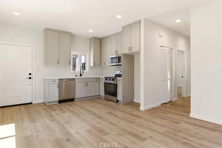 Unit B - The modern kitchen features custom cabinetry, stainless steel appliances, and modern finishes.