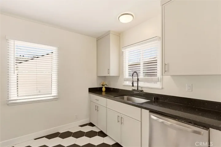 As you step through the dining room, you enter into this charming, stylish kitchen.