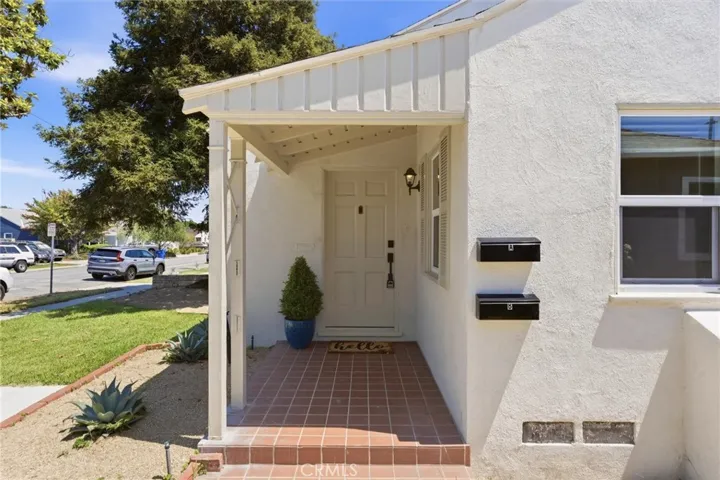 A charming covered front porch creates a warm and inviting entrance to this beautifully remodeled home.