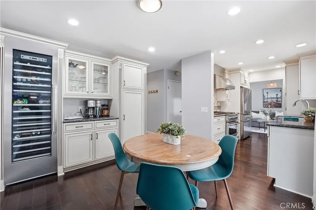 Built in cabinetry with glass door inserts - perfect for a coffee bar or whatever beverage of your choice. Dual zone wine fridge or and additional storage.
