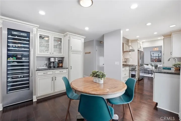 Built in cabinetry with glass door inserts - perfect for a coffee bar or whatever beverage of your choice. Dual zone wine fridge or and additional storage.
