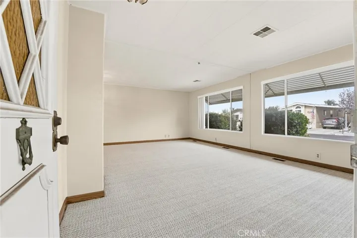 Living room is spacious with plenty of natural light!