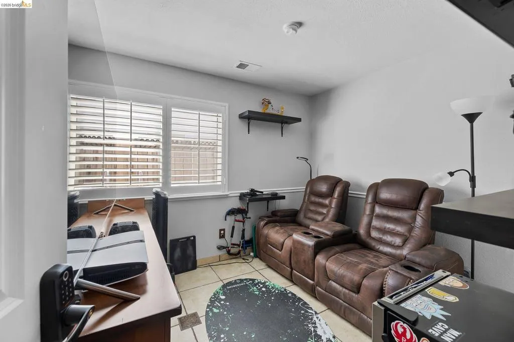 Light gray interior walls complemented by white window trim and plantation shutters