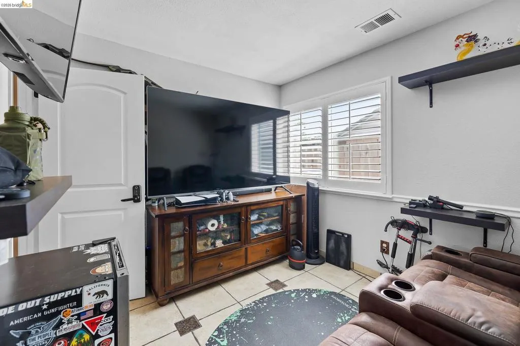 Room featuring neutral wall paint and tile flooring with accent squares