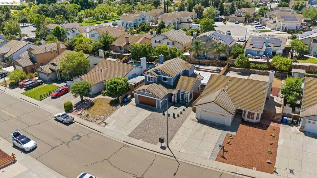 Two-story residence featuring a blue exterior with white trim, an attached garage, and a concrete driveway