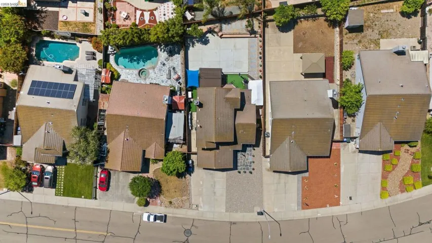 Aerial perspective highlighting multiple properties with varied rooflines and front yard landscaping